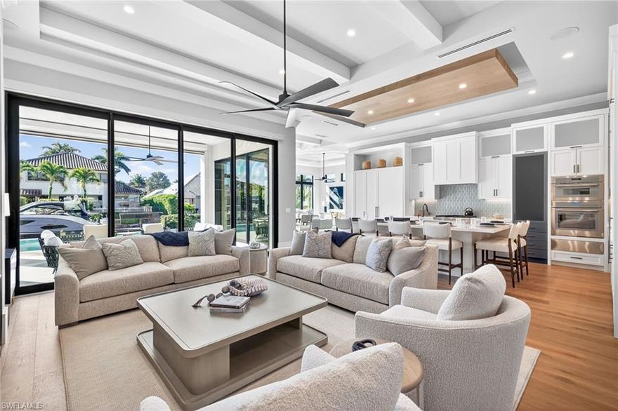 Experience refined coastal living in this newly completed, designer-finished and furnished canal-front residence offering coveted southern exposure, a private dock with direct Gulf access, and a premier walkable setting just moments from Naples Bay Resort, Bayfront, and world-famous 5th Avenue South, as well as Naples’ iconic white-sand beaches. Built to the latest 10-foot base flood elevation, this waterfront home reflects modern architecture, exceptional craftsmanship, and seamless indoor-outdoor living.

Offering 4 bedrooms plus a study and sitting area, 4.5 baths, and 3,617 square feet of light-filled interiors highlighted by a grand 12-foot foyer, wide-plank European white oak floors, architectural ceiling details, and tranquil water views. The chef’s kitchen features an oversized island with polished Oceanshore quartz and premium Thermador panel-ready appliances, opening effortlessly to a dramatic great room with cathedral ceiling and custom built-ins.

The primary suite is a serene waterfront retreat with dual custom wardrobes and a spa-inspired bath. Outdoor living is equally compelling, with nearly 450 square feet of covered space, a fully equipped outdoor kitchen, and an expansive pool deck with heated pool and spa. Additional highlights include smart home automation, integrated audio, pre-wired security, and a whole-house Generac generator.

An exceptional opportunity in one of Naples’ desirable waterfront settings.