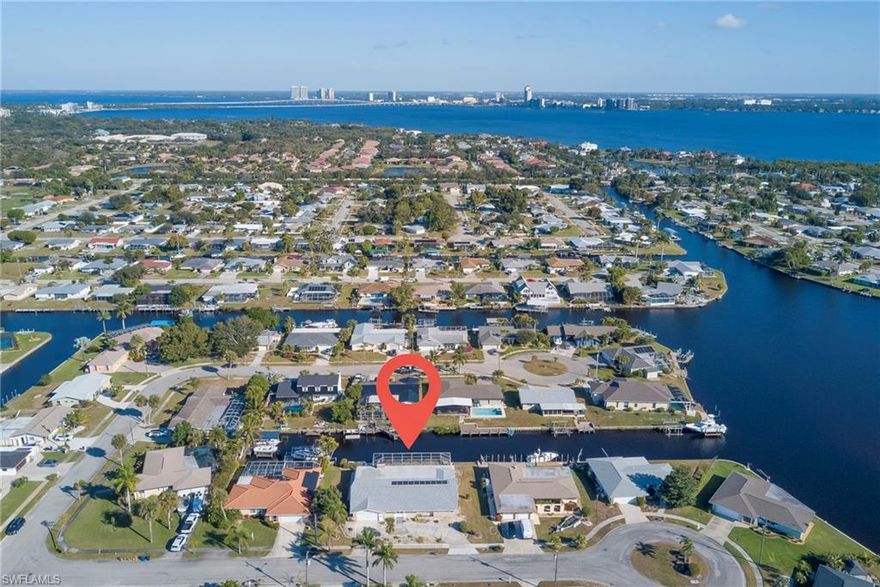 Experience true Florida living at its finest in this beautifully updated canal-front home offering quick, direct sailboat access within minutes to the Caloosahatchee River. Complete with a seawall and concrete dock—perfect for boating and waterfront enjoyment. With over 120 FT. of water frontage, gives ample opportunity to create your dream boat dock and lift to accommodate your vessel.  Step outside to your private oasis featuring a solar-heated pool, a spacious under-truss lanai, and an outdoor grilling area with a convenient pass-through window, ideal for entertaining year-round.

This home functions well for a growing family and entertaining guests with 2 living areas and an open kitchen. The home boasts a fully remodeled kitchen with white shaker cabinetry, granite countertops, and a double oven, seamlessly flowing into the formal dining area for both everyday living and special gatherings. The primary suite offers a cozy fireplace, creating a relaxing retreat. 

All three bathrooms have been tastefully renovated with granite countertops, tile finishes, and double sinks, offering comfort and style throughout. Additional features include an indoor laundry room with laundry tub and a private sauna for the ultimate at-home relaxation experience.

This exceptional property blends waterfront living, modern upgrades, and classic Florida charm—an opportunity not to be missed.