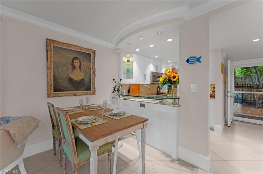 Once upon a time... this magical fairytale garden condo will take you to a dreamy place. Elegantly appointed with an open living dining room that is a perfect spot to relax after a day at the beach. The white tiled flooring and stunning crown molding have an elegant satin sheen The unique art deco solid wood doors give a decorator touch. In the kitchen, dramatic granite counters and breakfast bar pull it all together with a Fisher Paykel dishwasher and Bosch refrigerator. The primary bedroom featuring an ensuite bathroom with tub and shower, also has a large closet and is fit for a princess! The second bedroom with private ensuite bathroom is perfect for guests and also has a hidden stackable washer/dryer   Screened lanai that can be enclosed to add additional living space.   AC 7 years and.....There is a Lovely private pool with grilling area!  Never any hurricane damage. High elevation   Come live the dream in the Golden Triangle, that special place between iconic 5th Ave., wonderful 3rd St. and the fabulous Gulf   Walk to the Farmers Market, Art shows, Dining.