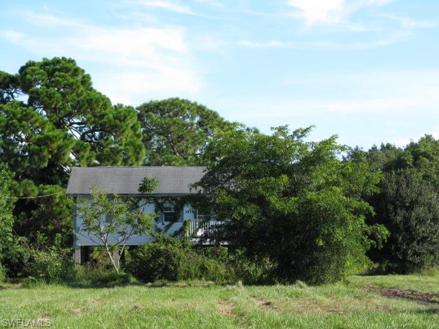 Stilt home set near the back of a 2-acre lot.  Central water/sewer.  Lots of room to expand.  Home needs lots of work, but only built in 2000.  To be sold as is, no warranties by seller or seller's agents.  House was vandalized and needs extensive repairs.  Will NOT qualify for financing.  
This propert is eligible under the Freddie Mac First Look Initiative for owner occupant buyers, true second home buyers and non-profit organizations until 12/23/2014.
Front exterior staircase is not accessible, nor is open porch on the second floor.  These portions of the house are not safe.  Back stairs have been restored for access.