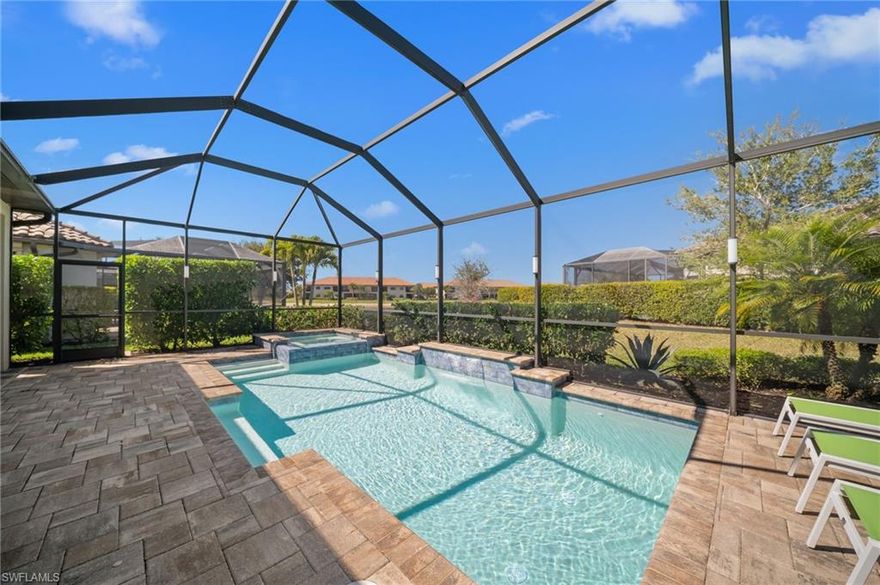 LIVE A VACATION LIFESTYLE IN ESPLANADE! FULL GOLF MEMBERSHIP INCLUDED! This immaculate and well appointed expanded “Lazio” is situated on a heavily landscaped and private lot with lake views. Inside, you will find 3 bedrooms, den, 3 full baths, and just over 2300 sq ft of open concept living space. 

From the moment you walk in the door, you are greeted with wood floors throughout the common areas and two sets of sliding glass doors to the extended lanai complete with custom outdoor kitchen, stained cypress ceiling detail, and stone accent wall with electric fireplace and enclosed by motorized roll down hurricane shutters. Catch some sun around the GAS & SOLAR heated pool with raised spa and amble deck space for sunbathing.  

The kitchen is the heart of the home and features shaker style cabinetry, Cambria quartz countertops, and stainless steel appliances including a GAS cooktop & wall ovens. The impressive  great room feature wall includes stone accents, custom cabinets, and built-in electric fireplace. Other fine appointments include: expanded kitchen with breakfast nook area and extra cabinetry; expanded primary bedroom bay window; air conditioned extended garage with finished epoxy floor and ceiling store racks; brand new HVAC unit; newer washer/dryer; plantation shutters on all windows; crown molding & custom millwork details; hurricane impact front door with matching sidelights; spacious Laundry Room with cabinetry; updated bathroom light fixtures; tankless GAS hot water heater; 8' doors/10' ceilings; and more! 

Esplanade Golf & Country Club of North Naples offers a true “Lifestyle Community” with world-class amenities, including a resort pool with cabanas and the popular “Bahama Bar,” tennis, pickleball, bocce, a 14-mile network of bike/walking trails, and an 18-hole private golf course. The impressive 15,000 Sq Ft clubhouse features a restaurant, bar, wine-tasting room, wine lockers, and a Starbucks-style café. Best of all, the property’s landscaping, irrigation, golf membership, and all community amenities are covered under a quarterly fee of just $3,743—no additional fees or memberships required! Don't miss your opportunity to own this exceptional home in one of Naples’ most sought-after communities. Schedule your tour of this stunning home and Esplanade Golf & Country Club today! COMING SOON TO ESPLANADE (2026): Fully renovated and expanded poolside Bahama Bar; expanded outdoor bar at the Barrel House; expanded golf practice range; and an AIR CONDITIONED INDOOR PICKLEBALL COMPLEX with four indoor courts.