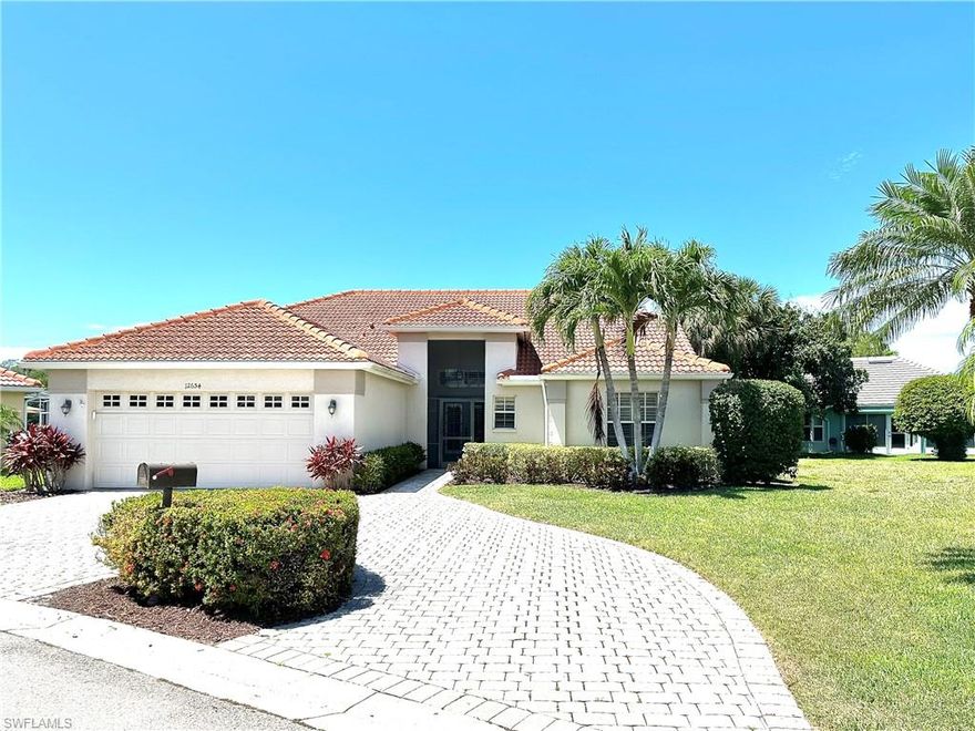 GOLF MEMBERSHIP INCLUDED ($50,000 VALUE) and Furnished.  This lovely single family home has a circular, paver, driveway, and a welcoming entry/foyer that draws your eye in to the spacious living room, adjacent kitchen, and outdoor living space.  The large living room has crown molding, a built-in feature wall, and glass sliders to the patio.  The home features an extra large covered lanai area, stretching the entire length of the house.  This is what Floridians want, a large covered area for afternoon shade and sudden showers.  Plus, the landscaped lot provides privacy for your dips in the pool and spa.  The pool is a free-form shape with wide curved steps into the water.  The  updated kitchen is well designed and very functional.  The upper cabinets are double stacked, and the top cabinets have glass doors and lighting, for an upscale and modern look.   The kitchen features a wine fridge, stainless steel appliances, granite countertops, under-counter lighting, and spacious pantry.  There is a breakfast bar, and room for a full size dining table.  The main bedroom and en suite has a custom walk-in closet, plus a 6' clothes closet, and linen closet.  The bedroom has sliding doors to the pool area, for convenience and natural light.  The 2nd and 3rd bedrooms are on the opposite side of the house, along with a 2nd bath and linen closet.   One of the bedrooms is currently furnished as an office/guest room.  There are tile floors throughout the home, and a newer AC and roof.  Hunters Ridge is a unique, smaller, private country club community.  All residents must be Social Members, and Golf Membership is optional.  There are 550 homes, and about 1/3 to 1/2 of the residents are golfers.  There are always lots of activities going on, golf tournaments, dinner parties, entertainment, etc.  Amenities include a pro shop, golf simulators, tennis courts, pickle ball, bocce, basketball hoop, resort-style pool, spa, and fitness center (currently being enlarged and updated). Residents get together for cards, crafts, games, fishing, etc.  The Country Club is "Private Golf" (preferred by most golfers), not "Bundled Golf" with a Chelsea System for tee times.  The lifestyle in Hunters Ridge is casual, friendly, and welcoming.  It has the convenience of everyday shopping just outside the gate, only 6 miles to the Bonita Beach, and less than 10 minutes to Naples and Ft Myers for more casual and upscale restaurants, shops, and entertainment.  The club's restaurant offers a variety of dining choices.  The Grill Room has a friendly bar and tables for casual meals, while the Dining Room serves dinner parties, buffets, and brunches.  The large outdoor patio and bar is a common place to gather, for refreshment and light meals.  Food is also available poolside.  Hunters Ridge has one of the best locations, and is one of the best kept secrets.  It offers so much, yet reasonable in price, compared to all other "Private" Country Club Communities.
