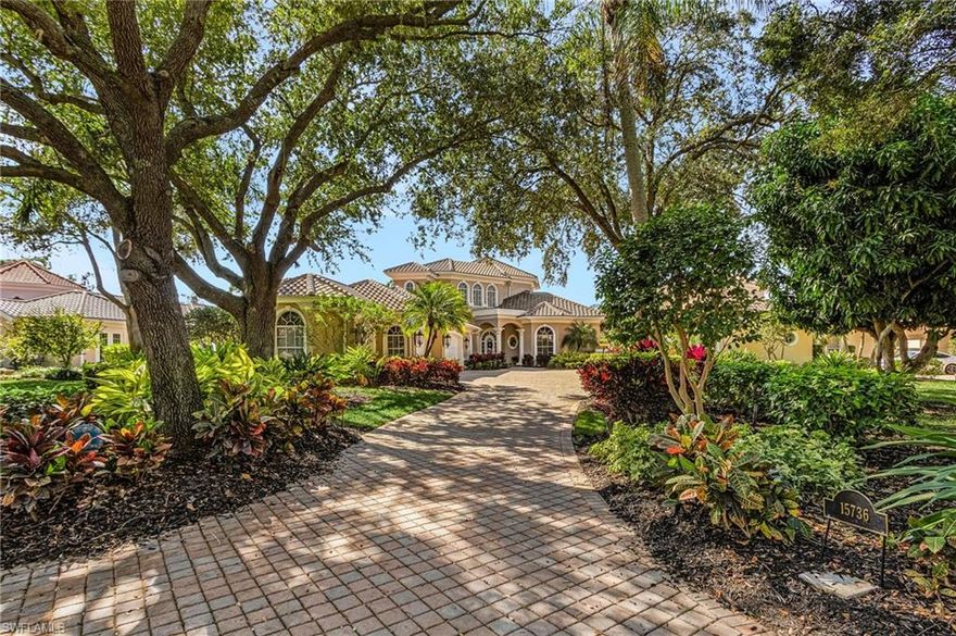 Nestled in the coveted St. Andrews subdivision of Fiddlesticks Country Club, this custom estate offers luxury living on a .4-acre lot with panoramic lake and golf views of the 8th hole on the Long Mean course. A long driveway under an oak canopy leads through lush landscaping—mature oaks, palms, and Florida-native shrubs—to a Mediterranean facade of beige stucco, arched windows, terracotta-tiled roofs (replaced in 2018), and a covered portico entrance. The foyer features an arched front door, private elevator behind ornate gold lattice doors for easy multi-level access, and wrought-iron staircase to the second floor. The great room centers the home with coffered tray ceilings, arched windows/doorways for natural light, and views to the pool, lake, and fairway. The Tuscan-style kitchen has distressed wood cabinetry with ornate panels, dual islands (one seating four bar stools), dual sinks, dual dishwashers, dual ovens, built-in refrigerator, and coffered ceiling. Cabinetry continues to a laundry/workroom linking to a bonus bedroom/den and four-car garage. A door off the kitchen opens to a second patio with fountain and built-in grill for easy outdoor cooking. Formal dining off the kitchen includes arched windows overlooking the second patio and fountain, chandelier, crown molding, and arched niches with shelving. Five bedrooms + den: downstairs guest suite with ensuite, bonus/guest off kitchen, two upstairs ensuite guests with walk-ins and terrace access overlooking pool/lake/golf. Master suite has his-and-hers baths (his as pool bath), both with walk-in closets and walk-in showers; hers adds jacuzzi tub and multi-head shower with body jets. The home is offered fully furnished, providing a seamless transition so the new owner can start living the Fiddlesticks lifestyle right away. Outdoor space includes a freeform heated pool with dedicated lap lane, hot tub featuring stone water fountains on both sides, and travertine deck with southwest exposure for afternoon sun. The open-air (unscreened) design feels resort-like, plus a covered lanai with arched columns and ceiling fans for shaded dining. Fiddlesticks Country Club offers two championship golf courses with putting greens, chipping areas, driving range, and pro shop; eight Har-Tru clay tennis courts (one of the top programs in Southwest Florida); pickleball/bocce; zero-entry pool with cabana bar/poolside dining; fitness center with trainer; dog park; clubhouse with formal/casual dining; and year-round social events. St. Andrews is an easy walk or golf cart to the clubhouse, with convenient back gate to Briarcliff as a bonus. Under air: 4,748 sq ft | Total: 6,618 sq ft (including garage and outdoor spaces). Click the virtual tour for floor plan, Zillow Floor Plan Tour, and video walkthrough. Schedule your private showing today to experience this exceptional home and the Fiddlesticks lifestyle firsthand.
