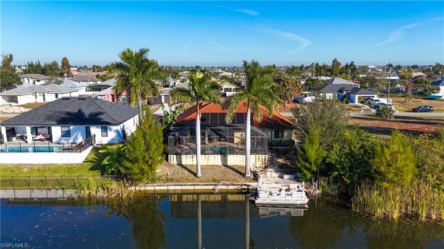 Discover the ultimate in Florida waterfront paradise with this stunning home in the highly sought-after SW Cape Coral neighborhood. Perfectly positioned on a serene freshwater canal, this property delivers breathtaking water views, prime fishing, and the relaxed, boating-friendly lifestyle that makes Cape Coral legendary. Step inside to an inviting open-concept layout filled with natural light and luxurious modern upgrades. The upgraded kitchen is a true showstopper, featuring granite countertops, high-end stainless steel appliances, a spacious pantry, a large breakfast bar perfect for casual dining or entertaining, and abundant storage space—ideal for whipping up meals while staying connected to family and friends. When the weather is right open the pocket sliders, that completely disappear into the wall, seamlessly blending indoor and outdoor living space. Open them wide to create an unobstructed flow to your private outdoor retreat. Outside awaits your personal oasis: a sparkling pool with panoramic views over the tranquil freshwater canal right at your back door. The concrete dock and seawall make it easy to enjoy kayaking, paddleboarding, fishing, or simply relaxing by the water—true Southwest Florida living at its finest!