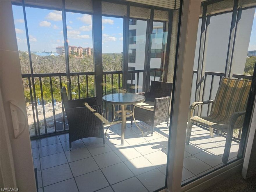 Enjoy expansive views of the pool and preserve stretching toward Estero Bay from this 4th-floor corner end-unit condo, with the beach just across the street—perfect for days in the sand and evening Gulf sunsets. This light-filled 2-bedroom, 2-bath residence at Estero Cove offers relaxed island living with great amenities and an affordable price point.

The open-concept layout features new carpet throughout with tile in the kitchen and baths, ceiling fans, and a bright kitchen with double stainless-steel sink, white refrigerator/freezer, dishwasher, range, black over-the-range microwave, and a breakfast bar with seating. The kitchen flows into a spacious dining area and living room, all opening to the screened lanai with peaceful pool and preserve views.

Impact Glass Sliding doors open to the lanai from both the living area and the owner’s suite, allowing coastal breezes and natural light to fill the home. Storm shutters on the windows and lanai provide added privacy and peace of mind. The primary bedroom includes a walk-in closet and ensuite bath with step-in shower, along with an impact-glass slider to the tiled lanai. A nicely sized guest bedroom features a generous closet, window overlooking the front balcony, with a full guest bath nearby. A laundry closet with stackable washer and dryer is conveniently located in the guest suite hall area. Estero Cove offers a heated pool and sundeck with tables, umbrellas, and loungers, along with a sport court featuring tennis, pickleball, and shuffleboard—ideal for enjoying the Florida lifestyle. CVS, 7-Eleven, and Santini Plaza are close by, offering restaurants, shops, a marina, farmers market, and trolley stop—all just minutes away.