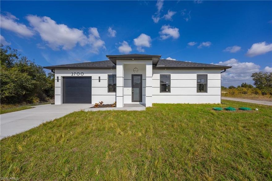 One or more photo(s) has been virtually staged, AI generated or rendered.  NEW CONSTRUCTION, luxurious contemporary home situated on a large corner lot, offering extra space, privacy, and great curb appeal. PRIMELOCATION!! 4 minutes drive to 7 Eleven and 82 RD, making errands quickly and essay. This home is impeccably designed and built with attention to every detail. All lights throughout the home are LED, all doors and windows are high impact and includes a sprinkler system. The open floor plan seamlessly blends indoor & outdoor living. Impeccable white 36x36 porcelain title floors with membrane under tile, which prevents cracks from wear and tear. Expansive living room with high 8" interior and exterior doors. The kitchen boasts gorgeous 42" solid wood soft close cabinets with quartz countertops, a broad counter height island along with stainless steel appliances. This home is approximately 10minutes' drive to the main shopping centers, restaurants and retail areas, THE BEST SW FLORIDA CAN OFFER