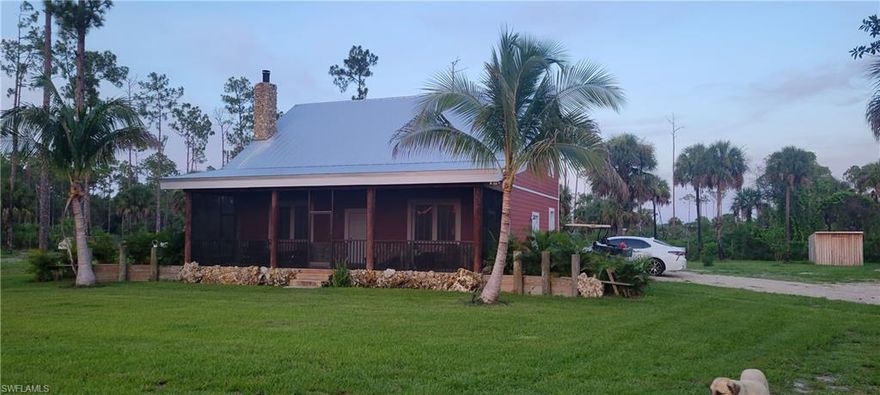 This custom-built residence offers timeless craftsmanship and enduring strength in a serene Redlands-inspired Naples setting. Designed and
constructed by the grandson and nephew of the original Cooper Historic Home, the property reflects exceptional attention to detail and structural integrity. The home’s 27-foot ridge beam and rafter ceiling are made of Southern yellow pine, while the reinforced construction exceeds hurricane code requirements. A coral rock fireplace and chimney create a distinctive focal point that complements the nearly three-acre landscape and 321 feet of Fakah Union Canal frontage, teeming with bass, snook, tarpon, bluegill and peacock bass. The privately gated and fully fenced property ensures security and privacy. A screened front porch with microscreen panels and paddle fans provides a comfortable outdoor living area. Inside, an integrated Marantz and Polk audio system delivers premium sound throughout the interior and exterior spaces. The residence includes two bedrooms and two baths, with potential for expansion to additional living areas. A new 2,400-square-foot detached garage by Georgia Southern Steel provides ample space for vehicles, equipment and storage. Combining resilient construction with authentic South Florida character, this property offers a private retreat just minutes from Naples amenities.