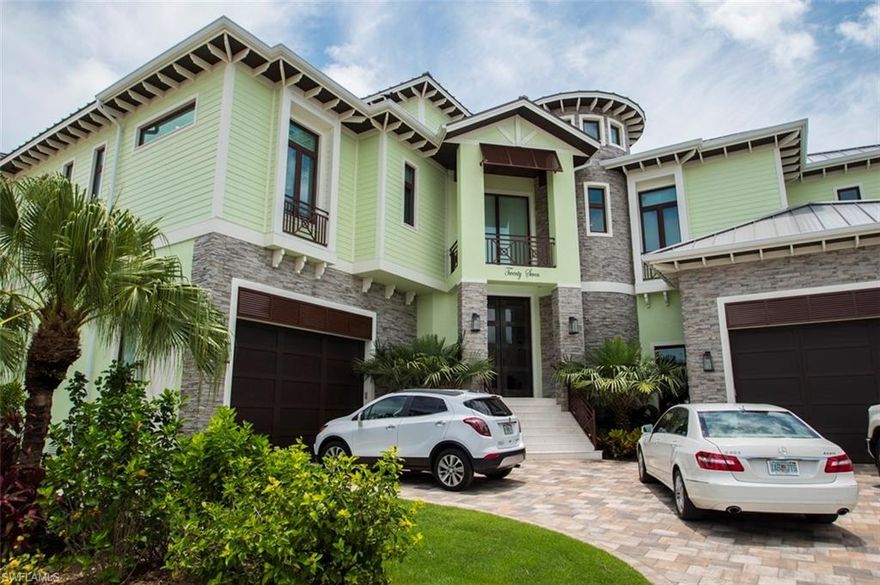Stunning Bayfront Elevated Pool Home at the Waterfront entrance of the coveted development of Fairview Isles on Fort Myers Beach.