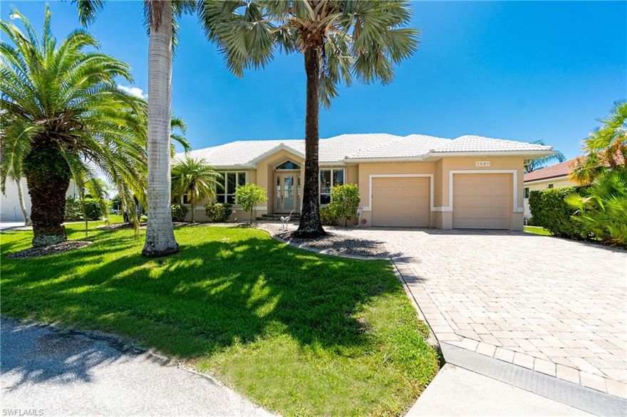 This maintained & well thought out canal home is perched at the end of a cul de sac, only 12 minutes to the newly constructed Buckley Pass! You will certainly be impressed from the moment you step inside this open floor plan accentuated by soaring ceilings & views.  The totally renovated kitchen is the centerpiece of this home with rich wood cabinetry featuring hidden outlets, custom pull outs, insets, & stainless display units topped with handsome granite. The induction cook top & built-in convection ovens are sure to keep your company well fed! Wake up with a view of the water from the master suite, which features a tray ceiling, plantation shutters & sliders to lanai. The two year old A/C system will keep you cool all year long! Staying organized is a snap with the custom closets, garage rack & cabinet storage plus bonus storage. A boater's dream with 99' seawall, 60' dock & 10K lb lift where you can legally accommodate two boats! Tide Slides, and kayak roller are two handy features you are sure to love! The over-sized garage provides great storage, & houses central vac, water softener & utility sink. The full hurricane shutter package makes closing up a snap when traveling.