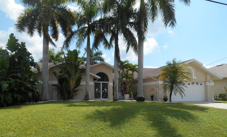 What a great deal on a Gulf Access waterfront pool home in the SW with all assessments are paid!  This house has lush landscaping with lots of royal palm trees gracing the property.  There is a paver walkway leading to a screened double door entry with pavers. Entering the home you have a view of the living room looking out over the pool and canal.  The master bedroom is spacious and the master bath has an oval tub, separate shower plus his and hers walk-in closets.  Any chef will really enjoy all the room this kitchen has!  Lots of counter space, a center island, all new stainless appliances and even a desk area.  The large family room is in the back of the home so you can take advantage of the waterfront view and pool area.  The fiberglass pool is very easy to maintain & requires very little chemicals.  There is also a full pool bath outside including a shower!  Add to this a walk around boat lift, good size dock, large mango tree & a roof that was installed at the end of 2004 will make this one of the best buys available.  Just a straight shot to the river & a short trip to Tarpon Point & Cape Harbor. Don't delay, put this on your must see list today!  Tomorrow may be too late.