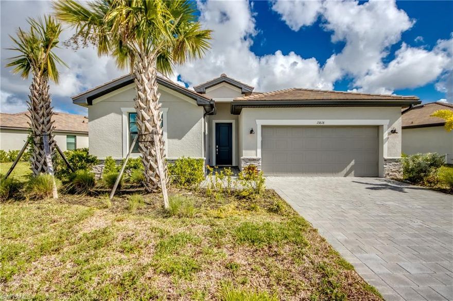 This waterfront Trevi model offers a rare combination of modern design and resort-style living within the gated community of Timber Creek in Fort Myers. With approximately 2,032 square feet of living area, this single-story home features 4 bedrooms, 3 bathrooms, and a split floor plan that includes an ensuite bedroom with its own dedicated bath. The owner’s suite is a private retreat with dual walk-in closets, dual sinks, and a large walk-in shower. The open-concept design seamlessly blends the great room, dining area, and kitchen, where designer cabinetry, quartz countertops (including every bathroom), stainless steel appliances, and a central island combine functionality with style. This home has been upgraded with wood-look plank tile flooring that runs throughout the entire home, complemented by impact windows and doors for security and peace of mind. Outdoor living is enhanced by a 20' x 8' covered, screened lanai overlooking the water, creating a perfect space for both relaxation and entertaining. Timber Creek offers 24-hour security and a wealth of resort amenities, including a clubhouse, resort-style pool, state-of-the-art fitness center, sauna, arcade, splash pad, and both indoor and outdoor dining, all just minutes from JetBlue Park and RSW airport. Designed for versatile living, this Trevi model balances everyday comfort with a desired community lifestyle at its best.