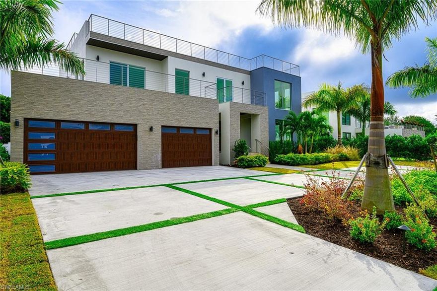 This spectacular 5372 sq ft home with roof top deck is now ready. This home features 4 bedrooms 6 bathrooms and is perfect for entertaining.  The 1st fl has an open living design with beautiful kitchen and living room areas and a guest bedroom.  The kitchen has custom cabinets, natural quartzite countertops, gorgeous crushed shell backsplash along with Miele appliances to make this kitchen special.  The home also features custom remote controlled blinds. Two sets of pocket sliders access the covered lanai and outdoor kitchen.  Outside you will find an inground swimming pool and spa with sun deck.  Access the second floor via the pneumatic elevator or custom staircase.  All bedrooms on the second floor are en-suite and have access to a balcony directly from each room.  The master bedroom has an incredible walk in closet and spa like bathroom.  The roof top deck with outdoor kitchen and bath must not be missed.  The view is amazing!  The home also has a three car garage  with storage area.  This home is a must see!