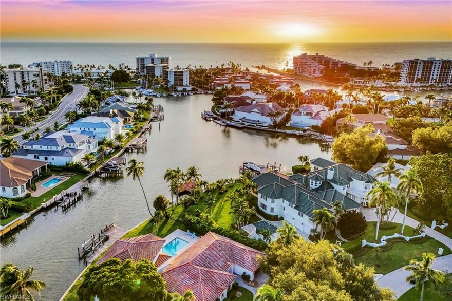 Waterfront legacy awaits in Naples, Florida! Welcome to 350 Bowline Bend an unparalleled opportunity to claim your legacy within one of Naples' most desired and tightly held communities, the magnificent Moorings Park "Nifty Fifty." Every aspect of 350 Bowline Bend confirms its status as a foundational address, an undeniable property where location, size, and waterfront distinction converge. This is far more than just a home; it is an irreplaceable canvas of endless opportunity in the heart of Naples—a private piece of paradise in the prestigious MOORINGS neighborhood. What makes this property truly extraordinary is its unique position as one of only 50 elite homesites located west of Crayton Road with WATER DIRECT access to the Gulf. Boating connoisseurs will recognize the immense value of the oversized, 155-foot seawall frontage—one of the largest in the Moorings—on a deep-water canal featuring large turning basins and a 10,000lb lift, ensuring you have ample space to dock your yacht and enjoy DIRECT Gulf access with NO bridges. The property sits perfectly on a quiet cul-de-sac and spans a remarkable 20,475 SqFt LOT, offering generous dimensions (60x180x155x180) that are simply unmatched in this area, all blessed with the highly coveted WESTERN EXPOSURE that promises breathtaking, fiery sunsets over the water every single evening. Suitable for only those who seek the absolute best of Naples- Opportunity here is limitless, awaiting the vision of a discerning buyer to create a new, trophy estate; yet, the current well-maintained residence is instantly livable, beautifully renovated in 2022 to feature six bedrooms, a dedicated theatre room, and four full baths. As you enter, you’re greeted by a light, bright, and airy ambiance, with a large open concept that seamlessly connects the oversized kitchen and living spaces. Two living rooms, an eat-in kitchen, formal dining, and a media room enhance the home's functionality, perfect for luxurious entertaining, while large bay windows frame stunning water views from every room, creating an ideal blend of indoor and outdoor living. This location is second to none, placing you nestled near the sun-kissed beaches, the vibrant lifestyle of The Moorings, and Downtown Naples, including the renowned 5th Avenue South and historic 3rd Avenue South. This is the definition of luxury Naples living, where every amenity is at your fingertips. For the visionary, only seeking the absolute BEST of Naples, 350 Bowline Bend is the address for you—a private, and definitive trophy waterfront foundation that has all the makings to be the city’s next biggest gem.