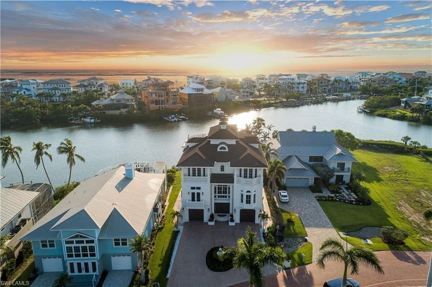 Beautiful home with spectacular Bay views, located in the double-gated “Bayfront” neighborhood of Collier County’s premier “Barefoot Beach” community. Delight in breathtaking wide bay views from nearly every room & prime Western exposure for magnificent sunsets over the pool/spa. Only a 5-minute walk to the beach or a 10-minute boat ride to the Gulf from your dual private boat lift. Built like a fortress, this home is crafted with all concrete construction, hurricane impact windows/doors throughout, and a new roof (December 2020)! Other features include soaring high tray ceilings with Brazilian mahogany, 8 ft mahogany doors, travertine marble floors, and 3 new HVACs. Gorgeous chef’s kitchen features parallel granite islands, butler’s pantry, custom cabinetry, professional-grade appliances with dual Subzero fridge/freezers, Wolf gas stove, 2 ovens, steam oven, dry/wet warming drawer & a wine fridge. Spacious primary bedroom has a spa-like bathroom with a large shower with multiple showerheads, separate tub & walk-in closets. Offers the finest features & finishes such as a whole house water purification system, surround sound, full security system & elevator. Bayfront Dr. homes are built on one side of the street, providing homeowners optimal privacy & views of the Bay.