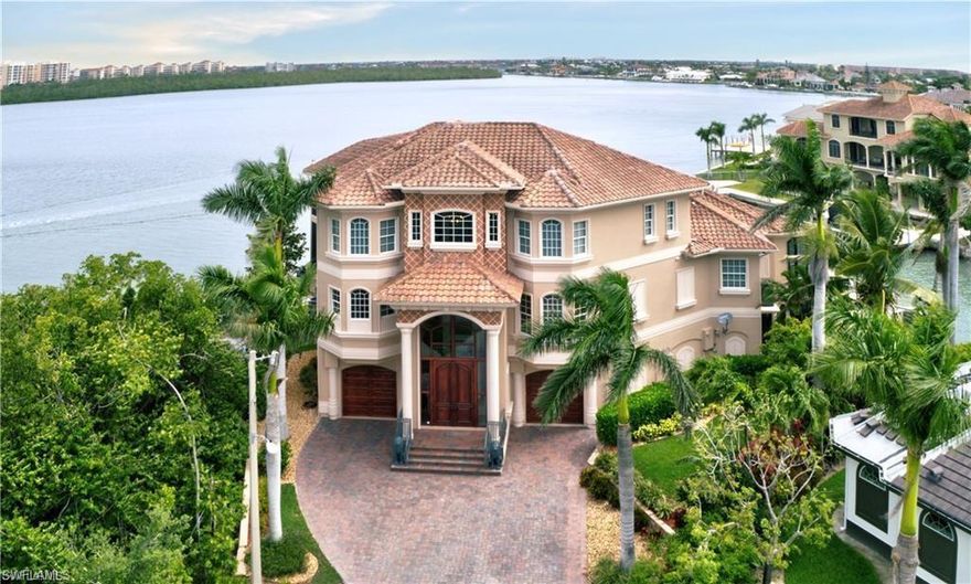 Marco Island's TREASURE - ONE OF A KIND RARE TIP LOT offering the Ultimate in PRIVACY- Boasting 192’ of Pristine and Awe-Inspiring Waterfront views and EXPANSIVE 60ft DOCK for your Yacht! This custom home was built by APM Builders, renowned for unique features in each ceiling. Has 30' boat lift, plus a lift for two Sea-Doos. There are no bridges and only minutes to the Gulf! Enjoy a front row seat to the Lighted Boat Parade from the huge deck offering spacious outdoor living, a Gazebo, outdoor kitchen, a spacious covered lanai, plus a second floor infinity edge pool and waterfall spa. Elegant and Sophisticated, yet comfortable and functional, with incredible attention to detail. Marble and wood flooring grace this home with timeless elegance. Two Master Bedrooms plus 2 additional, each offering it's own en-suite bathroom. The Den could be a 5th bedroom if preferred. The Gourmet kitchen offers solid wood cabinets, granite counters, luxury appliances and access to the butlers pantry equipped with wet bar and wine cooler. The family room offers zero edge sliders opening up to the pool and sun lit lanai. Truly a unique home that you MUST EXPERIENCE!  TURN-KEY!