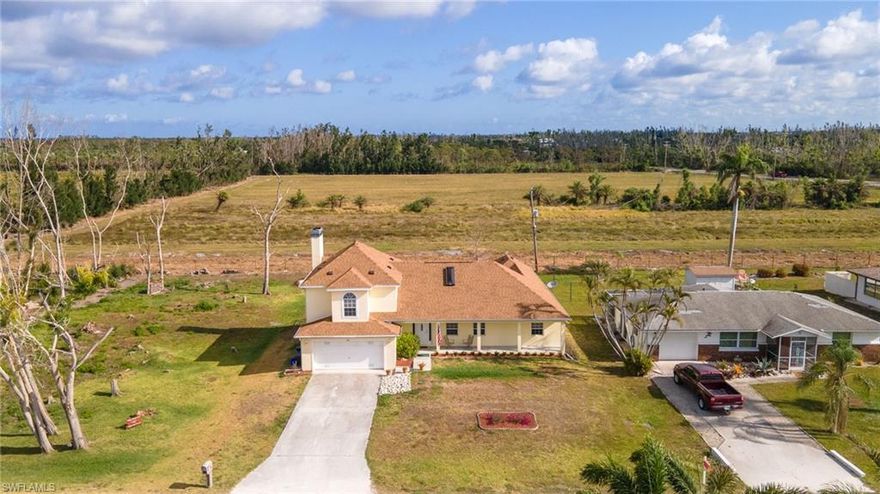 Live comfortably in this spacious 3/3 island home. Close to Pine Island Center! Walk or bike to the Pine Island community pool, sit and relax at the park pavilion, or enjoy a ride through the island nature trail. This beautiful Pine Island home features a split floor plan, with 2nd floor master suite with his/her amenities and jetted jacuzzi tub. Outside the master suite is a loft style space, (would make a great home office or hobby room) and private sundeck with views of the north end of the island. Property backs up to agricultural land, no need to worry that a house will be built close by!! Enjoy views of swaying palm trees and recent new addition four cows and one baby calf. (Looks like another is on the way) Head on downstairs, to the open and airy kitchen with eat in breakfast bar, formal dining area, and enclosed patio space. Relax and unwind, in the family room and/or living room with working fireplace.  Also on the first floor is a nice size guest bedroom/bath and second master suite which is handicap accessible with bonus room/den and private patio. This home truly has it all! New roof 2022, brand new shed 2023.  Book your showing today to see this amazing island home.