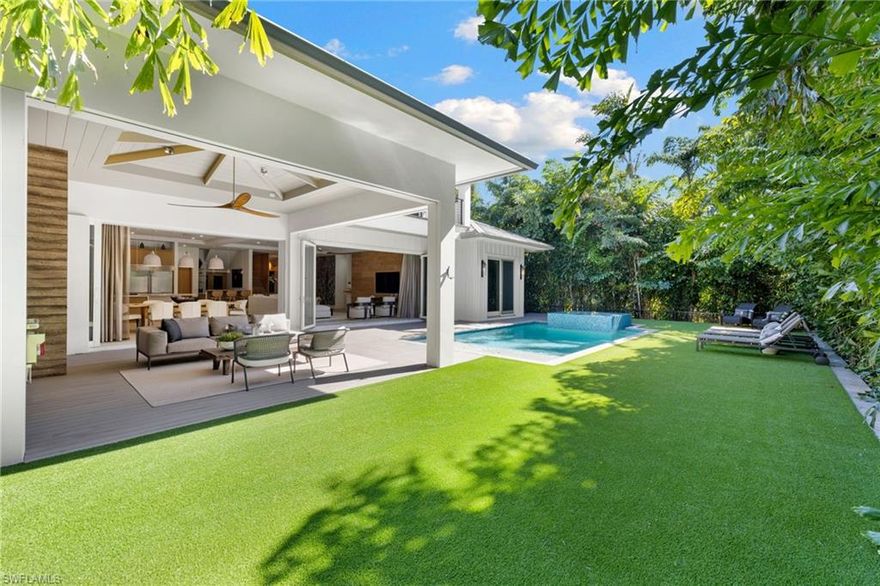 Located near the Gulf of Mexico in the heart of Olde Naples, this single family home offers a blend of elegance, sophistication & coastal charm with timeless appeal. The meticulously designed interior features impeccable craftsmanship & finishes while the open-concept layout provides an airy ambiance filled with natural light. A blend of functionality & aesthetic beauty, the gourmet kitchen boasts top-of-the-line appliances including a Lacanche range & custom cabinetry. Equipped with retractable screens, the covered lanai with summer kitchen offers a seamless transition from indoor to outdoor living and leads to the saltwater pool & spa, enveloped by lush landscaping. Unwind in the comfort of the primary suite, a retreat that exudes tranquility with a spacious ensuite featuring a soaking tub, walk-in shower & dual vanities. Each of the additional four guest bedrooms is thoughtfully designed with its own ensuite bathroom, providing privacy & comfort. In addition, the home is equipped with Lutron lighting, Sonos, climate-controlled garage, and a ChargePoint Home Flex EV charger. A wine room, study, lounge, powder room & pool bath further enhance the functionality & ease of living.