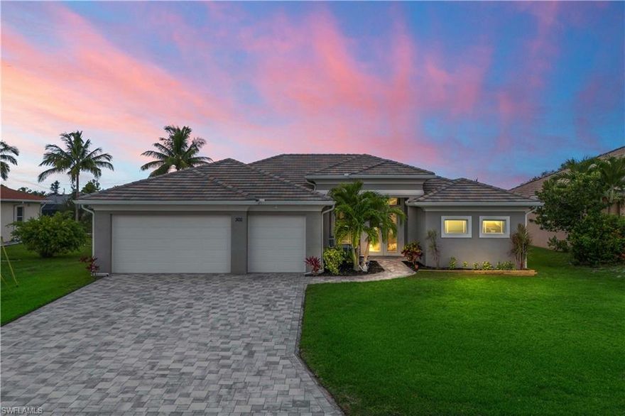 Set along a quiet canal with coveted southern rear exposure, this custom residence offers refined Florida living with space, light, and thoughtful design throughout. With 2,520 square feet under air, the home features three spacious bedrooms, two and a half baths, a dedicated study, and a three-car garage—ideal for both everyday living and hosting guests. Sunlight fills the home year-round, while expansive 90-degree corner sliders create a seamless connection to the screened lanai and pool, capturing beautiful sunset views. Outdoor living is elevated with a fully equipped summer kitchen, supported by a 400-pound propane tank that also services the indoor range. Inside, volume ceilings, custom cabinetry, granite countertops, and quality finishes set a clean, upscale tone, complemented by tile and luxury vinyl plank flooring throughout. Impact glass, a tile roof, and paver driveways add both durability and curb appeal. Located in desirable SW Cape Coral, close to dining, shopping, and waterfront recreation, this home is move-in ready and thoughtfully crafted for those who value comfort, quality, and location. Experience it firsthand with a private showing.