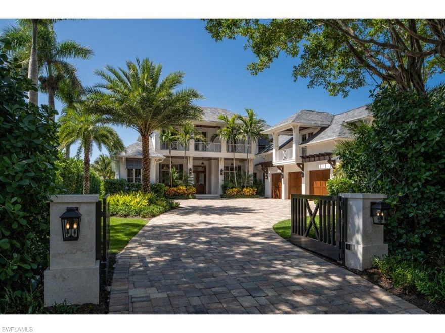 Nestled beyond the gated entry and lush landscaping at 1100 Galleon Drive, one is greeted by a large motor court and tasteful architecture. This luxurious home, with preferred southwestern views over Runaway Bay, has been remarkably enhanced with modern amenities and smart home features sought after by today’s buyers. Thoughtfully designed with entertaining in mind, the large kitchen fuses with the open family room and gracious outdoor covered terrace; the perfect space for casual entertaining.  If play turns formal, celebrate in the delightful configuration of light-filled living and dining rooms. A first floor master bedroom, guest suite, and den are complimented by four en-suite bedrooms on the second level with a separate large family room. Relax by the negative-edge swimming pool or enjoy lawn games in the substantial and extremely rare green space afforded by the unique depth of the property. Significant new floating dock with two lifts. Three car garage. An exciting opportunity to enjoy the quintessential Naples experience without the time required to build new. Port Royal Club membership eligibility.