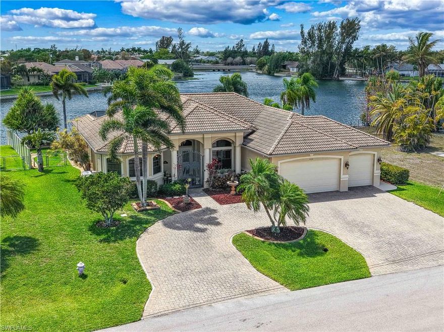 Experience true Florida living in this meticulously maintained waterfront pool home offering stunning big water views and highly desirable southern exposure. Boasting over 2,500 square feet, this spacious residence features 3 bedrooms plus a den, 2.5 bathrooms, and a 3-car garage, all located in Flood Zone X where flood insurance is NOT required.
Designed for both everyday comfort and entertaining, the home offers an open-concept kitchen with a pantry that seamlessly flows into the main living area, along with an additional separate living room for added flexibility. The den can easily serve as a home office or optional fourth bedroom. The expansive primary suite is a true retreat, featuring two walk-in closets, dual vanities plus a third dedicated vanity space, a walk-in shower, and a relaxing soaking tub, and sliding glass doors that open directly to the lanai.
Step outside to your private outdoor oasis where beautiful, mature landscaping leads to a massive wraparound dock complete with a tiki hut, boat lift with canopy cover, and a floating dock. Perfect for boating, kayaking, or fishing right from your backyard. Enjoy over 8 miles of canal access from your property.
The oversized lanai is built for entertaining, featuring an outdoor kitchen, pergola, and a solar-heated saltwater pool, along with convenient access to a half bath. The fully fenced yard also includes a separate fenced dog run.
Additional highlights include a tile roof, circular paver driveway, whole-home generator with a 500-gallon propane tank, security system, electric storm shutters on the lanai, a screened garage door, central vacuum system, water filtration system, and an air-conditioned storage space within the garage.
Ideally located with easy access to shopping, dining, and entertainment, this exceptional home offers the best of waterfront living with everything Cape Coral has to enjoy just moments away.