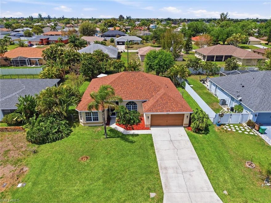 Welcome to your own slice of Florida living in a prime Cape Coral location! Conveniently located near restaurants, shopping, and schools, this single-family pool home with no HOA is a true gem offering comfort, space, and exceptional value. This property is not in a flood zone, offers city water with all assessments paid, and features major updates including a new roof (2024), A/C (2021), and new appliances, giving buyers peace of mind from day one.

Enjoy a spacious layout featuring 3 bedrooms plus a den, perfect for a home office or guest room. The large open living area is filled with great natural light, creating a bright and welcoming atmosphere throughout the home. Triple sliding glass doors open to the expansive lanai, creating the perfect indoor-outdoor living experience. The oversized lanai offers plenty of room for outdoor dining, grilling, entertaining, and relaxing by the pool while enjoying the Florida lifestyle.

Step outside and enjoy your private backyard with mature fruit trees, including mango, avocado, and guava, perfect for enjoying your landscaping, harvesting your own fruit, and creating a true Florida oasis. One of the home’s most unique features is the large walk-in pantry with its own sink, located just off the kitchen, an exceptional convenience and a true standout for anyone who loves to cook or entertain.

This home truly has it all; natural light, space, major updates, outdoor living, and endless potential. Offering exceptional value in a fantastic location, opportunities like this don’t last long, schedule your private showing today and see it for yourself!