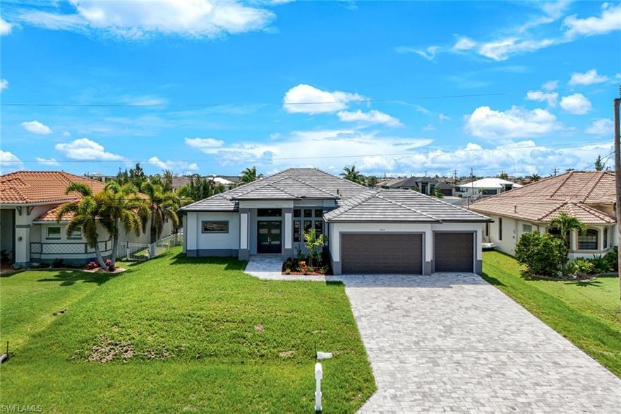 BIG PRICE IMPROVEMENT! Welcome to the best of Cape Coral luxury waterfront living! CO received and ready for occupancy! Step inside this brand new gulf access home with modern style, sleek lines and a clean color palette; it's your private canvas to create the look and feel you desire. Gleaming, large tile floors throughout, soaring ceilings, 8' interior doors, three-panel sliders and abundant sunlight create a bright, open feel perfect for entertaining and enjoying. The chef's kitchen has a huge Quartz double-waterfall island, stainless steel appliances, glass cooktop, double-wall oven, and adjoining dining area with water views. French doors off the kitchen/living area open to a bright six-window possible fourth bedroom (with closet), or an inspiring office, hobby room, or den. Relax in the large owner's suite featuring a high tray ceiling, floor to ceiling tile feature wall over a deep soaking tub, walk-through dual shower, separate vanities, ample closet space, and enclosed water closet. The guest wing offers two more bedrooms, a full bath and a full pool bath with direct access to the lanai and connected to the rear guest bedroom creating a second private ensuite living space perfect for visiting guests. Soak up the sun and water views from the huge lanai with an inviting pool and spa and outdoor kitchen ideal for entertaining friends and family. For inclement weather this home’s got you covered with a tile roof and hurricane-rated windows and doors. Your cars and toys will have their place too in the large three-stall garage. Set in the desirable Northwest waterfront community surrounded by other luxury homes, you won’t find any better locale in Cape Coral for boating, fishing, dining and shopping. And Florida’s famous white-sand beaches are just a short boat or car ride away!