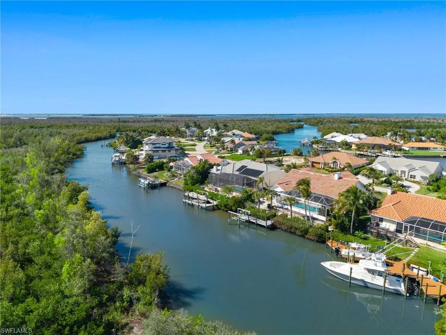 The Florida waterfront home you’ve been waiting for is now available in Palm Acres! Meticulously maintained by the original owners, this high ceilings Somerset V model built by Arthur Rutenberg Homes is situated on 90ft of saltwater canal frontage overlooking a picturesque mangrove shoreline. Elevated high and dry, full coverage flood insurance with lowest deductibles is currently only $1,485 annually! This great room concept home with grande entry is gorgeous! Enter an immersive experience of soaring ceilings, plant shelves, transom windows, and pocket sliders where your eyes are drawn to the updated pool area complete with massive picture window pool cage. Recent updates include new tile roof, resurfaced pool, new pool cage, new electrical panel, new water heater, complete exterior paint, and freshly painted garage. Built in 1990 this gulf access boating home lives large with 2,461 sq ft of living, 3 bedrooms, home office, 2 full bathrooms, pool bath, laundry room, and spacious 2-car garage. The island kitchen is BIG with generous counterspace and optimal views of the great room, outdoor living area, sparkling pool, mangrove shoreline, deep canal, dolphins, manatees, sport fish, and dozens of bird species. You will LOVE your bedroom, bath tub, oversized shower, and walk-in closet! Outdoor living includes inviting lanai, new wet bar, pool, garden beds, and a pathway to your private dock. Look at the photos. Watch the video. And call now to come take a look!