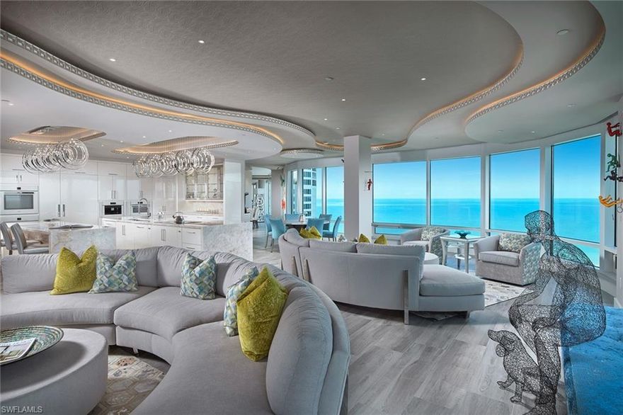 Paradise in the sky, this posh Provence penthouse is captivating with Gulf-to-Bay views that will take your breath away. As soon as you enter the private entrance, double doors open to the crisp color of the turquoise Gulf and you will feel at ease. Dramatic luxury; wood grain tile in a modern gray tone provides the perfect backdrop for pops of color throughout while being family and pet friendly. Stainless linear fireplace sets the tone for a romantic seating area while the serpentine ceiling detail gives elegance to the modern lines.  Ideal for hosting family and friends, the double island gourmet kitchen opens directly to the great room framed by floor-to-ceiling window walls. After sunset hour on the private rooftop deck, owners can unwind in the chic master bedroom seating area while guests retreat to one of the 4 spacious guest suites. Perfectly imagined, this 20th-floor residence leaves no luxury to be desired with the Control4 system, top-of-the-line Miele appliances, Cristallo Quartzite countertops, wet bar with built-in wine cooler and so much more. The Provence provides a myriad of amenities, all just across the street to shopping and dining in the Venetian Village.