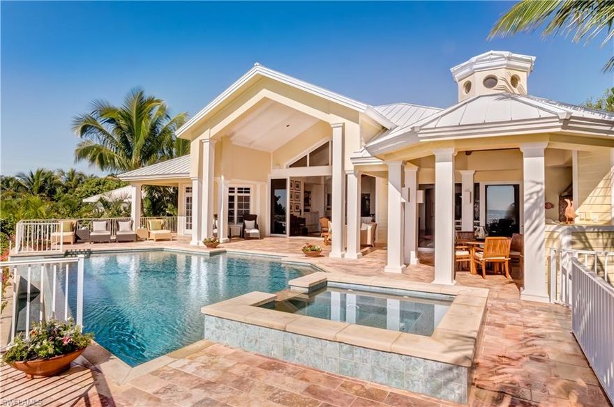 Set on the Gulf of Mexico, this exquisite home elicits all that is beachside living in the tropics. As you approach you are surrounded by lush mature plantings and majestic royal palms which guide you to the entry toward a courtyard to the main house. The moment you arrive at the front door your eye is drawn through the great room over the invisible edge pool to the emerald waters of the gulf. This beautiful residence was designed for today's living with a stellar great room concept encompassing a chefs kitchen, spacious dining, gorgeous wet bar, and a most comfortable living area all of which open to the waterside. Walls of pocketing glass disappear and welcome you out to the covered lanai as well as tanning deck, outdoor kitchen, spa and a heavenly pool. The master suite spans the west side of the main house, is finely appointed with a Calcutta marble bath and two walk in closets. This home is also unique in that it has a guest house attached by a short covered breezeway.