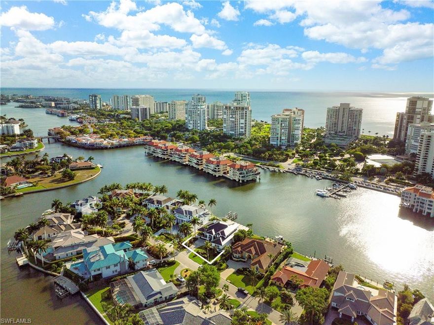 Upon entering this spectacular home, you will be captivated by the stunning straight though views of Venetian Bay and Florida nature at its finest. Then at the day's end, you will enjoy some of the most dramatic and colorful sunsets found anywhere in Naples. As one of the most coveted waterfront locations in all of Park Shore, this home captures both long and wide western bay views on the prestigious Neapolitan Way, tucked away from busy Crayton Road yet only minutes to fine shopping, dining, and entertainment by car or boat. This home was masterfully renovated in 2017, the waterfront was expanded with nearly 100 feet of maintenance-free decking, and a 48-foot walk-around slip with a 16,000 lb lift for the serious boater. The first floor has the master bedroom with redesigned bath, adjacent office, and a very private guest suite enjoying wide bay views. The second floor has guest room three with an open balcony to enjoy spectacular sunsets and for the non-sun worshipers, guest room four is light and bright with the cool morning sun. The oversized 2 car garage is expandable. Park Shore residents have private beach access on Park Shore Beach.