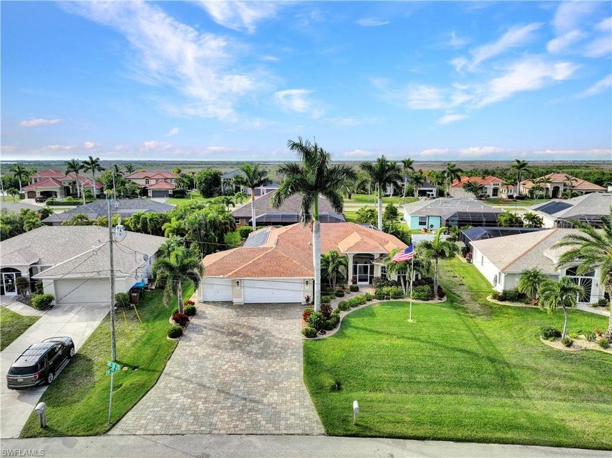 Location, Location, Location Just off the multi-million-dollar Surfside Blvd is this tough to find 4 Bedroom pool & spa home with a 3-car garage. You’ll love the new, huge paver driveway, and the lanai also has all new pavers. West exposure offers those world-famous SW Florida sunsets and a hurricane roll down shutter was also added in 2022 to protect the lanai furnishings. Recent pool upgrades include a Pentair system, high efficiency pool pump, pool heater plus solar pool heat panels and screen enclosure screens.  You will also get a NEW ROOF, and 6” gutters, hot water heater, dishwasher, range and the home was re-plumbed with PEX. In addition to the 4 bedrooms there is also an office/den, large enough to be a good size family room. New window treatments all around include Plantation shutters in all the windows & blinds for the sliding glass door and pool door. You’ll love the master suite with dual vanities & closets, plus a gorgeous shower & soaking tub. This well-maintained home has beautiful landscaping offering privacy on the lanai and it also has a fence yard for the pets. This is a prime neighborhood and convenient to everything.  All Assessments Paid.  Take a look today.