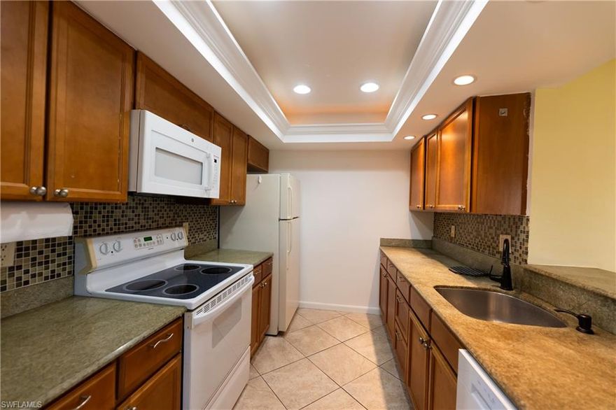 Annual Year Round Rental READY NOW! Discover this wonderful one bedroom one bath residence located on the top floor of a quiet three story building with no neighbors above you. Enjoy fantastic views overlooking the seventh green, fairway, and shimmering lake. The western exposure provides beautiful sunsets every evening and a peaceful outdoor setting. This community is situated on a public golf course with the option to join, and there are no required golf fees. Pay as you play and enjoy the luxury of having the course right behind the property. Residents also enjoy a relaxing pool and spa area with scenic golf course views. The building offers an elevator and the unit includes one covered carport space. Rental includes Water, Sewer, and Basic Cable which is provided by the HOA. Publix is located next door along with convenient nearby shopping and dining. Olde Naples and the beaches are only five miles away.