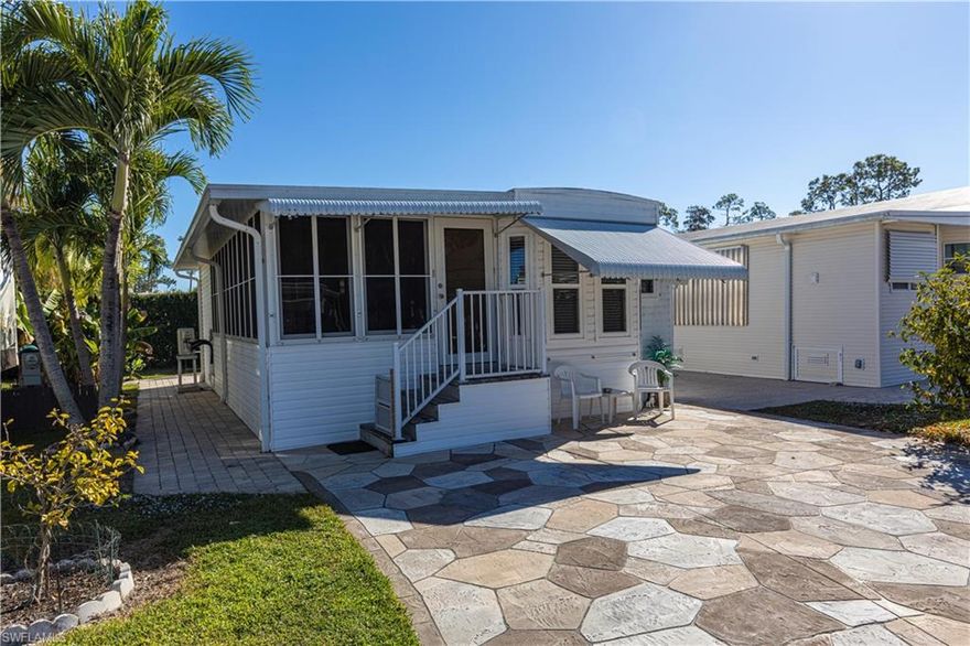 Welcome to the beautiful, active, gated, 55 plus community of Imperial Wilderness where you OWN the land.  This home has many very nice features including a nice workshop. The first thing that you will notice as you pull up to the home are the nice pavers. While it does not have central air, it stays nice and cool with the 2 mini splits.  The lanai was upgraded in early 2009. The park model side has pretty laminate floors that are only 2 years old.  The bath has quite a bit of room with a lot of storage for your linens.  The bedroom has new window with an egress window for fire safety.  You will love the comfortable, homey feeling that you get when you step inside this house.  The biggest feature is that once you enter the home, you will not have to deal with any steps.