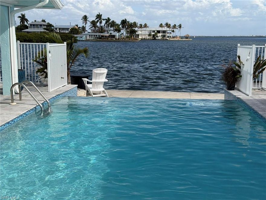 Experience old Florida island living at this incredible waterfront cottage home on Matlacha Island featuring massive 180-degree water views, a huge private pool, an authentic Seminole Indian Cheekee hut, and your own private boat ramp. This is not just a canal cottage — it’s a full waterfront lifestyle property designed for relaxation & entertaining with unforgettable views & memories! 
This charming yet spacious "turnkey-furnished" 2-bedroom, 2-bath cottage retreat blends comfort with classic Florida Keys island character. Inside, you’ll find a large bright open kitchen with plenty of room for cooking and gathering, perfect after a day on the water. The home offers a king bedroom and a queen bedroom, each equipped with its own full bath for easy relaxation.
Step outside and the property truly shines. Take in sweeping 180-degree waterfront views that stretch across the open water — ideal for morning coffee, cocktails, kayaking and everything in between. The private infinity edge pool offers plenty of room to cool off, lounge, and entertain. The oversize Cheekee hut provides shaded outdoor living space with outdoor living furniture and tropical charm, making it the perfect spot to unwind.
For boating enthusiasts, the private boat ramp makes launching up to 30' boats effortless & your own private Kayaks are also available for exploring the surrounding pristine backwaters at a slower pace. The BBQ grill, gas firepit and covered outdoor living add extra convenience to your stay.
Located in the heart of Matlacha Island, you’re just a 2 minute walk to local favorites like the waterfront Yucatán bar/restaurant, The Perfect Cup for breakfast & coffee or the Blue Dog Bar/Restaurant & all the colorful shops, galleries that make Matlacha’s laid-back fishing village atmosphere directly outside your door.
Whether you're here to relax poolside, fish, boat, or explore the charm of this vibrant island community, this waterfront retreat offers the ultimate Florida getaway for couples, families, or friends seeking space, views, and true island living.  Call for details... DEC- APRIL = WEEKLY @ $1950 PER WEEK... (Monthly discounts available)     MAY- NOVEMBER = 3 NIGHT MINIMUMS ALLOWED $295 PER NIGHT