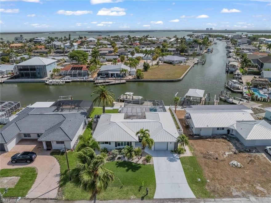Look No Further! For your DIRECT GULF ACCESS CANAL FRONT POOL HOME on Fort Myers Beach! If you are a boater and beach lover, then this magnificent 3 bedroom 3 full bathroom home is for you!
This home is COMPLETELY NEW inside displaying elegant, luxurious, coastal style. This waterfront concrete block home has no stairs so you can drive up, walk in and begin enjoying the island beach lifestyle. The newly installed underground irrigation system maintains the lush tropical landscaping that surrounds the property. Multiple security cameras on the property will stay with the home. Bright and spacious living area opens up to a large lanai overlooking the heated in-ground pool, and the new composite, maintenance free deck and boat dock with power, water and a new fish cleaning station. The large white porcelain faux-marble flooring gives the home a luxurious feeling. The kitchen offers beautiful cabinetry, quartz countertops with a convenient rolling center island. Please view the video link for a virtual tour.  Arriving home after a nice boat trip or a walk down the beach you can relax and cool off in the gorgeous swimming pool. The private, enclosed patio is adjacent to the pool and deck and is beautiful in the daytime and magical at night. Dolphins and manatees are a frequent delight, swimming right up to the dock. This property is situated on intersecting canals and offers expansive long water views. Take your boat less than half a mile and you will find yourself in Estero Bay with unparalleled backwater fishing opportunities. By boat, this home is 2.5 miles to the Gulf, Lover's Key State Park and Dog Beach. For the beach lovers, this spectacular home is less than 500 steps from the sugar white sand beach that we are so famous for.  The highly desirable Fairview Isles area of Fort Myers Beach is very close to Publix, CVS, 7-Eleven, Santini Plaza, Fish Tale Marina, popular shopping, restaurants, and coffee shops. The South-end location also allows quick and easy traffic-free access to Bonita Beach, Naples and the Southwest Florida International Airport.  Don't forget to watch the virtual tour video. Welcome to your new Fort Myers Beach home.