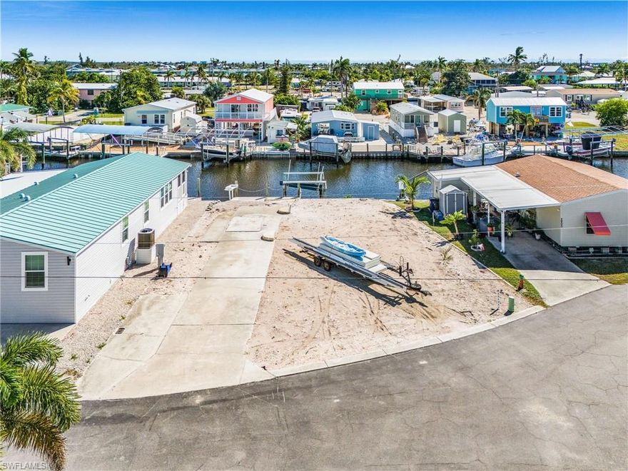 Start fresh on this waterfront lot on the south end of Pine Island.  Located near the cul de sac, this cleared lot has nearly 50 ft. of water frontage, a composite dock, fish cleaning station, driveway, and a boat lift that may need repairs.  There was a mobile home on this property that was recently removed.  With the convenience of sewer and water in place, bring in another mobile and pay no impact fees, or put in a modular or build a single family home and only pay the difference between a mobile and house in impact fees, a savings of several thousand dollars.  Offering quick, deep water access to Pine Island Sound and the Intracoastal.  Just a short boat ride to the beautiful Gulf of Mexico beaches on the barrier islands, and some of the best fishing in Southwest Florida.  Enjoy the convenience of hopping on your golf cart or bicycle and in minutes being at all the restaurants, bars, shops, and fun that St. James City has to offer.  Don't wait....Buy now, build your dream home, and enjoy the island life!