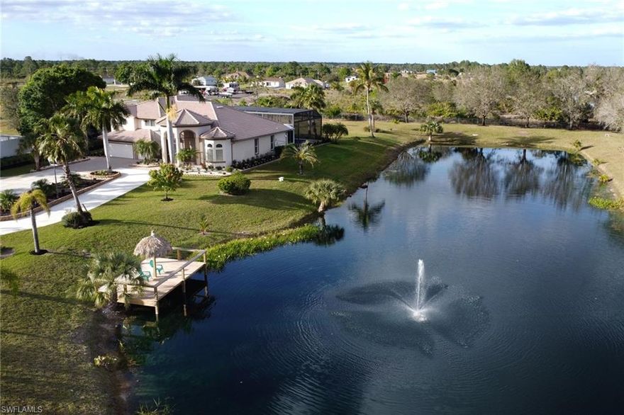 This beautiful Custom built home sits on 5.6 Acres of completely fenced in cleared land with a large lake great for fishing.  Nestled next to a Canal this truly picturesque property offers 4 Bedrooms, upgraded 3 1/2 bathrooms, Spacious living area with vaulted ceilings and a large closed in lanai area with summer kitchen and a heated in ground pool.  No HOA's, electronic security gate, spacious 3 car garage, and external outdoor shed for storage.  This custom home with so much acerage and a private lake is move in ready.