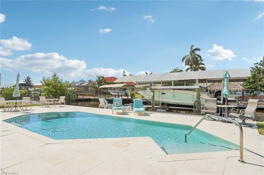 Fantastic North Naples waterfront home within walking or biking distance to Barefoot Beach and 15 minutes to open water via Wiggins Pass with no bridges. Located in Little Hickory Shores, this home has been extensively updated with concrete block construction, impact windows, shuttered lanai, newer tile roof, newer heated pool with marble deck, and a newer walk-around dock with 13,500 lb lift and covered canopy. Flexible 2+Office/Private Sitting Room's and 2 Bath layout with spacious master suite offering an additional private space. Baths have been updated with tile, cabinetry, and surfaces; the kitchen features upgraded cabinetry, appliances, and finishes. Outdoor living includes a covered lanai, large sun deck, and generous dock space ideal for entertaining or relaxing. Enjoy boating or kayaking directly to nearby waterfront restaurants. Coveted Collier County location with lower taxes, A-rated schools, and resident beach access.