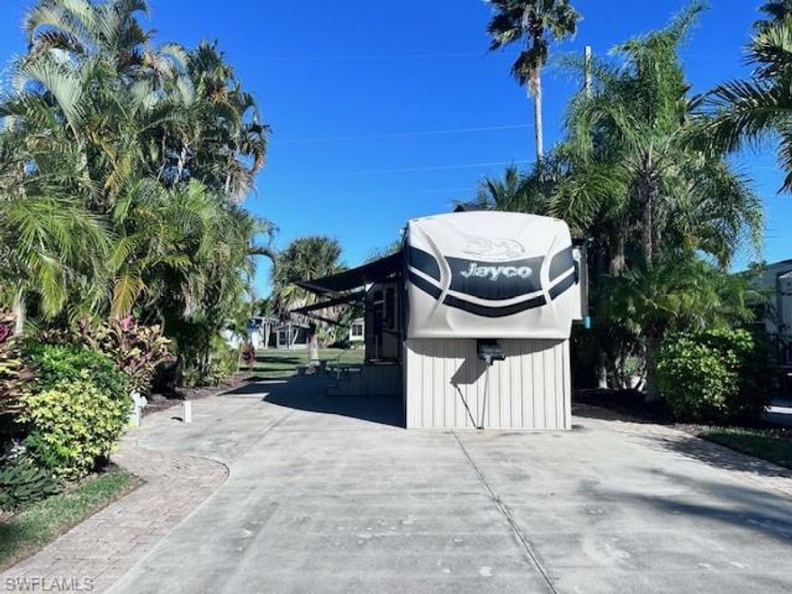 Turn-key opportunity to purchase both the lot and a well-maintained 2015 Jayco Pinnacle 36RSQS fifth wheel—priced less than many empty lots. This top-of-the-line Jayco features four slide-outs, a king-size bed, full-size residential refrigerator, washer and dryer, new fold-out couch, and new theater seating. Fully equipped kitchen includes small appliances, pots, pans, and dishes. This 35X70 RV Site is located on a quiet cul-de-sac at Sunset Point with wonderful afternoon shade. Jayco washed and waxed each season with a proactive silicone roof coating applied in 2025. Pavers on both sides and rear of lot, electric pedestals on both sides, and ample front storage. Move-in ready and ready to enjoy.