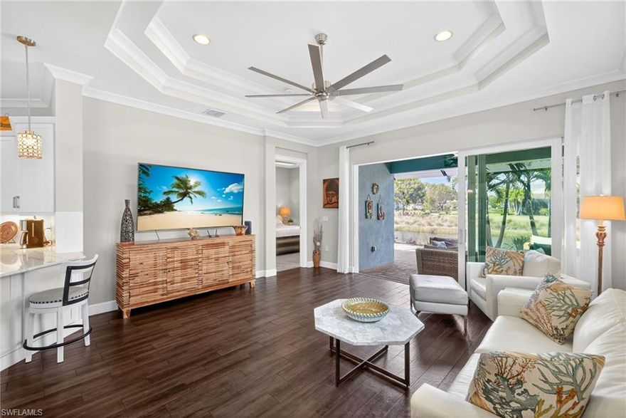 Discover this pristine, highly appointed Mimosa villa in the premier community of The Isles of Collier Preserve. This sought-after floor plan offers 2 bedrooms plus a den and 1,782 sq ft with serene water views from the screened lanai. The bright, open interior features plantation shutters, impact glass windows and doors, crown molding, tray ceilings, and plank tile flooring throughout the main living areas.

The chef’s kitchen includes white cabinetry, quartz countertops, subway tile backsplash, under-cabinet lighting, stainless steel appliances, double oven, and a large bar seating four. The primary suite offers a walk-in closet and bath with dual sinks and a spacious shower, while the den with French doors and Murphy bed provides flexible guest space.

Enjoy an extended lanai with remote Storm Smart Kevlar screen and resort-style amenities including tennis, pickleball, trails, and the Overlook Bar & Grill, just 4 miles from Downtown Naples and the Gulf beaches.