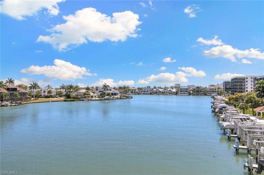 Boaters, this is the one you've been waiting for. Beautifully renovated, this top-floor Monte Carlo Club residence is a unicorn Vanderbilt Beach property with breathtaking expansive bay views, a boat dock included (the trophy feature) and direct beach access just across the street (the lifestyle amplifier), all behind a gated entry. High ceilings and abundant natural light elevate the interior, while the open chic design lives like a private retreat. Features include hickory wood floors, a renovated kitchen and baths, exceptional closets and storage, newer air conditioner, plus new boat dock mechanicals and lift (2025). With best views in Monte Carlo Club, the wide water view becomes the backdrop for morning coffee, sunset cocktails, and an easy, everyday rhythm that feels distinctly Naples. Move-in ready, this is the rare kind of property that checks all the boxes with boating, beach and renovated. Monte Carlo Club offers a resort-style lifestyle with a pool, opt-in tennis and pickleball, plus a covered parking space. Go outside and you are moments to the sugar sand shoreline of Vanderbilt Beach and within short distance to LaPlaya, The Ritz-Carlton and Turtle Club. A rare opportunity in a location that is nearly impossible to duplicate.