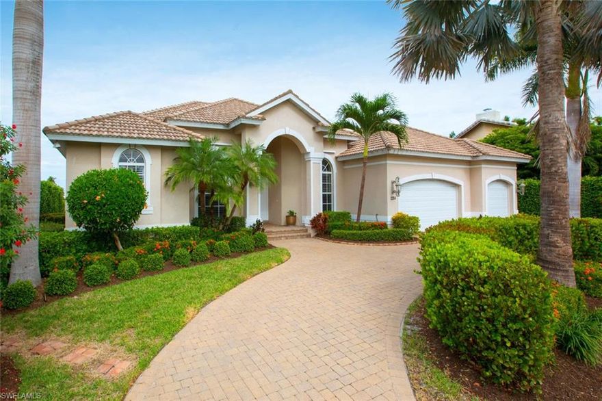 Stunning long water views abound from this magnificent home that shows like a model.  Gorgeous home boasts 3 bedrooms plus den, 3 car garage, pavered circular drive, soaring ceilings, diagonal tile flooring, crown molding, custom cabinets, disappearing sliders, granite countertops, new stainless steel appliances, new carpeting, newly painted interior and exterior, landscape lighting, underwater dock lights, and so much more.  Enjoy the beautiful views from the spacious pavered lanai and salt water pool.  Quick out to the Marco River from large dock with 10,000lb lift.