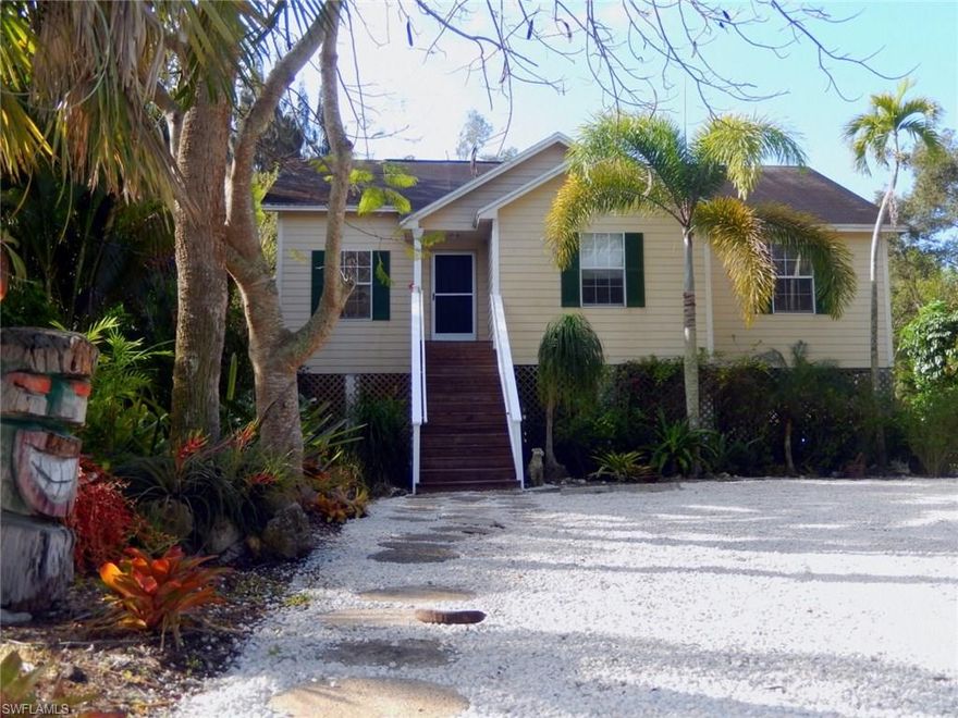 For those wanting a Natural Old Florida Tropical feel this little gem provides. Gardened with tropical plantings there is something to marvel in all seasons. Located off McGregor Blvd., south towards Sanibel Causeway, & close to Sanibel & Captiva Islands beyond. Easy access to grocery shopping &  Tanger Outlet stores. This Jim Walters concrete block piling elevated frame construction ranch was  built in 2003 & offers a volume ceiling in the great room that opens to the eat in kitchen, 3 bedrooms & 2 full baths, new carpet & new kitchen flooring, inside utility, & an open deck out back to enjoy a lush private view on almost 1/2 acre lot. ...& no HOA fees.
Underneath provides a huge open area to park cars, boats, ski-dos & all the equipment you desire. There is also a built in storage room below, perfect to lock up tools.   On central sewer, the house comes equipped with an RO water system, newer water softener & a recently serviced & cleaned tank & aerator. The 16 seer a/c system has a 5 year warranty remaining.  For your pet, a fenced in area contains out back. 
If you drive the  neighborhood a variety of large homes will surprise. This quiet little neighborhood is a unique find.