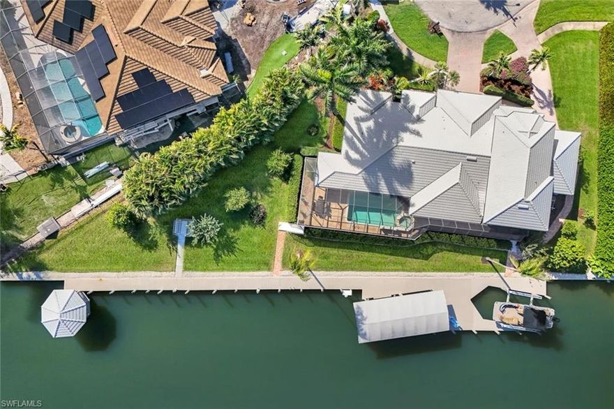 Experience premier waterfront living with this distinguished 5-bedroom, 4-bath residence, strategically situated on nearly half an acre with direct Gulf of Mexico access. This home is a boater's dream, featuring two advanced boat lifts—a 20,000 lb and a 27,000 lb lift, the latter protected by a canopy to preserve your vessel's condition. The property boasts an impressive 276 feet of seawall, complete with a private gazebo for enjoying stunning sunsets and bay views.

The recent remodel has transformed this luxurious abode, seamlessly blending contemporary elegance with comfort. High-end finishes and thoughtful design elements are showcased throughout, including new plank flooring and a beautifully remodeled kitchen, equipped with a large wine cooler. The spacious, light-filled interiors provide an inviting atmosphere, ideal for both sophisticated entertaining and private family gatherings. The kitchen features a convenient pass-through window, perfect for hosting parties or enjoying morning coffee at the window bar seating. The expansive backyard offers numerous opportunities for relaxation, from the glider swing to dining while surrounded by nature's beauty and fruit trees.  The home has an added wheelchair lift in the third-car garage opening into the master bedroom.

Venture outside to your private oasis, where a spectacular, heated pool with a spa offers the ultimate retreat for relaxation or entertaining. The meticulously landscaped grounds enhance the seamless connection between indoor and outdoor living spaces.  There is so much potential on this property!

Whether opting for a leisurely poolside afternoon, unwinding in the spa, or setting off on a boating journey, this exceptional piece of paradise embodies the quintessential Florida lifestyle. Conveniently located near shopping centers, grocery stores, the beach, and easy island egress, this rare gem offers a harmonious blend of luxury, convenience, and natural beauty. For the discerning waterfront connoisseur, this home truly has it all.
