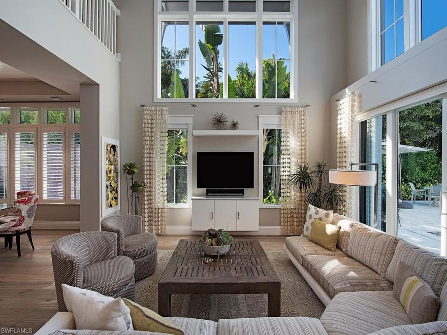 This Timeless Coastal Cottage sports a coveted first floor master and is awash with natural light which streams through two-story walls of glass.  This perfect location is just 1 block to 5th Avenue, a few blocks to the crystalline beach, restaurants and shops around the corner and an MHK, Waterside Builders and Clive Daniel product.  The gourmet kitchen gleams with a very large island and finishes of quartz, granite, Sub-Zero and Wolf supplied by natural gas.  The surprisingly private location with a generous yard has serene outdoor living, a waterfall wall, covered and uncovered seating, and a tucked away outdoor kitchen.  Aside from the two bedrooms and open loft upstairs, there is a second laundry room and a steam shower.  Above the garage with a private entry, a spectacular welcomes your guests with a living room, kitchenette, bedroom and bath.  This is the Queen of Downtown Living!