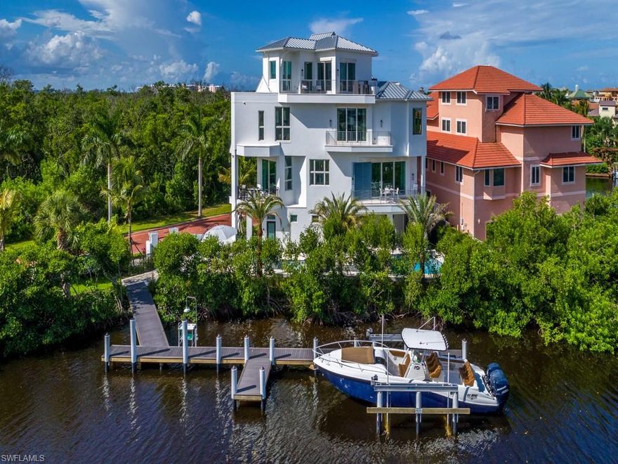 2019 HGTV ULTIMATE HOUSE HUNT FINALIST and for a good reason!!! Luxury waterfront living at its finest awaits you in this coastal contemporary waterfront home. Enjoy generous 3 Bedrooms, Den, 5-1/2 Bathrooms offering over 8,022 sf of entertaining space and 4,486 sf under air. Lounge on the 4th level observation area overlooking Little Hickory Bay, where a wet bar & fitness area open to an airy patio with outstanding water views. Wide plank European oak floors through out the entire home are complemented by custom crafted soaring ceilings with beams & square edge tongue & groove on every level. The upscale cabinetry throughout the home and gourmet kitchen was designed by Allikriste Cabinetry. Show off your gourmet talents with the top of the line 48" Wolf Range, all Sub Zero refrigeration, Miele coffee maker, 2-ovens and steamer. The private 95 ft pool deck with 7 ft waterfall, spa & flowing fire pots offer a spectacular day and night setting you must experience. Dock your boat on your private 80 ft dock with 20,000 lb lift. All of this just 1,000 steps to one of the world's top rated beaches in the world, Barefoot Beach boasting world renowned sunsets.