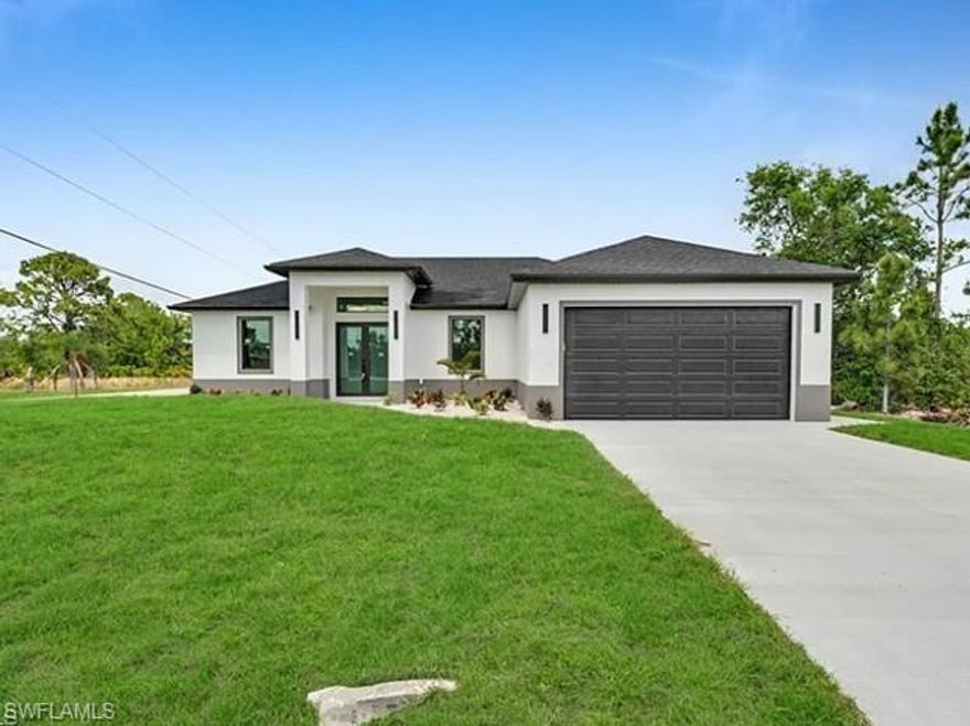 Stunning new construction home for rent in Lehigh Acres! This contemporary residence offers a perfect blend of luxury, style, and functionality. Featuring 4 bedrooms and 2.5 bathrooms, this beautifully designed home showcases a modern open layout with elegant porcelain tile flooring throughout. The spacious kitchen is ideal for both everyday living and entertaining, complete with a sleek L-shaped island, quartz countertops, European-style cabinetry, and Samsung Bespoke stainless steel appliances, including a touchscreen Samsung refrigerator.

The primary suite offers a true retreat with his and hers walk-in closets, dual sinks, and an elegant walk-in shower. Bathrooms feature stylish LED lighted mirrors, while floating modern vanities and European-style closet doors add a sophisticated touch throughout the home. Enjoy outdoor living in the extended lanai, perfect for relaxing or entertaining. Automated irrigation system for the lawn is included. Photos are of a model home and may not reflect the exact property. PID: 25-44-26-08-00042.0030.