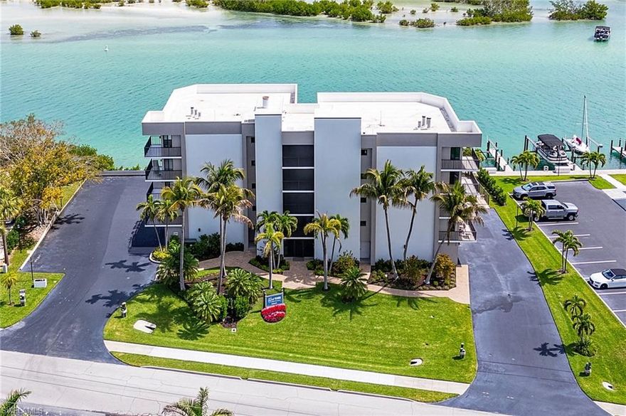 Love boating and beaching and breathtaking views of the bay and the Gulf? Then this is the home for you! A rare gem, this completely updated 2 bedroom, 2 bath Bayfront beauty is directly across from Bonita Beach and it is move-in ready. The spacious, immaculate condo includes a private garage, a private boat slip, two private storage closets and deeded beach access right across the street. The 8 unit, low density building has just two units on each floor with a large breezeway separating the homes. Windows on all four sides of the condo provide an abundance of natural light, and you have no shared walls with neighbors. All living areas boast amazing views of the bay and the Gulf, with all the flora and fauna SWFLA has to offer! Relax on your lanai and enjoy dolphins and manatees swimming in your own backyard!  Nothing to do but enjoy life here as everything has been done! The home has been updated with a soothing coastal decor and tasteful upgrades --The easy care wood-look plank tile flooring flowing throughout, the beautiful custom cabinetry and granite countertops in the kitchen and baths, and crown molding finishes.  The primary bedroom has a private balcony with a view of the Gulf for enjoying that morning cup of coffee or watching sunset with a relaxing evening beverage.  The ensuite bathroom has a spacious walk-in closet, raised vanity with granite countertop and dual sinks, a tiled shower and a linen closet. The guest area of the home offers lots of privacy for overnight visitors. The spacious bedroom accommodates two queen beds and a walk-in closet for extra storage.  The guest bath has a raised vanity with granite countertop and tiled shower. The wrap-around lanai is perfect for relaxing and watching the watercraft and wildlife.  You will have peace of mind with the new top-of-the line geothermal HVAC system, new hot water heater, and especially with all the new impact windows and doors. Storm shutters on the lanai provide additional storm protection.  Even the floor of the private garage has been enhanced with a beautiful epoxy coating. The private boat slip awaits your watercraft for back bay and Gulf adventures with Gulf access just a few minutes away. Or venture to the beach across the street for shelling and breathtaking sunsets. The Gulf Harbor complex has had a total storm recovery that includes new docks, new elevator, new roof, new lobby entry system, new landscaping, and refinished saltwater pool and spa plus much, much more. Deeded Beach access is right across the street. Gulf Harbor is pet-friendly complex located on the quiet north end of Little Hickory Island, home of beautiful Bonita Beach. The condo boasts amazing views to the east, south and west, and is one of the largest 2 bedroom, 2 bath condos available in the area. It's being sold turnkey and is move-in ready -- Add the private boat slip, private attached garage, 2 private storage closets, and deeded beach access, this is the one! Your next home in paradise!