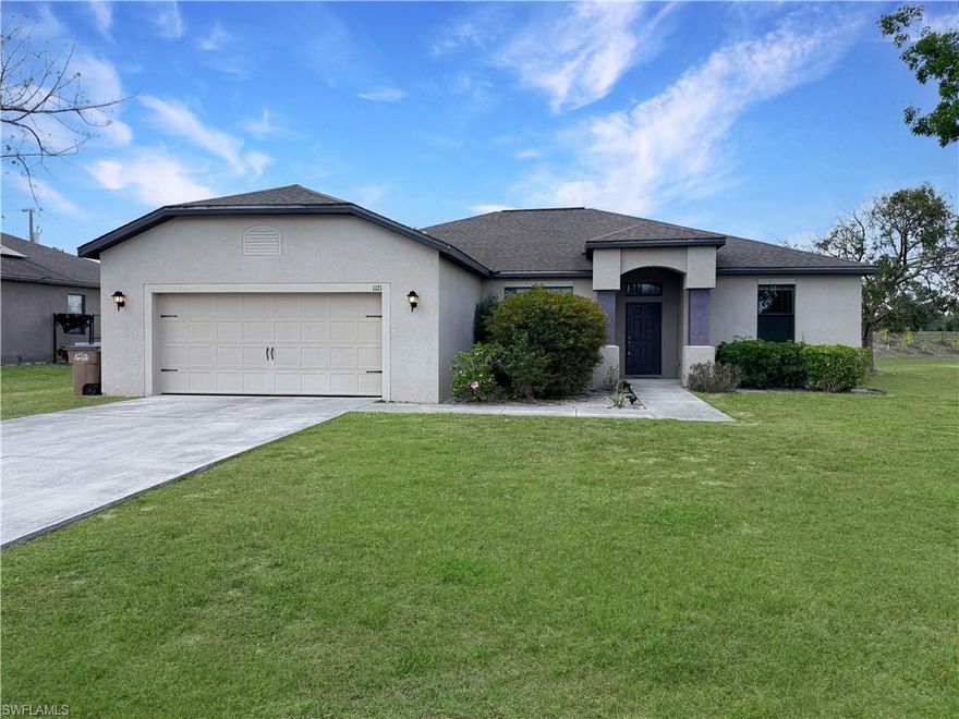 Not in a flood hazard area — most lenders will not require flood insurance! This spacious 4-bedroom, 2-bath home sits on a desirable corner lot with excellent parking and an open floor plan that creates a bright, welcoming space for living and entertaining. Features include low-balance water and sewer assessments, durable tile flooring throughout the main living areas, and plush carpet in the bedrooms. The oversized master bath is a standout, with a separate walk-in shower and relaxing soaker tub. Enjoy the comfort of a brand new A/C system installed in 2025.Conveniently located near shopping, restaurants, and schools. The lot features beautiful mature Barbados cherry and dwarf Meyer lemon trees and adjoins a short private access lane that provides plenty of off-street parking and added privacy.