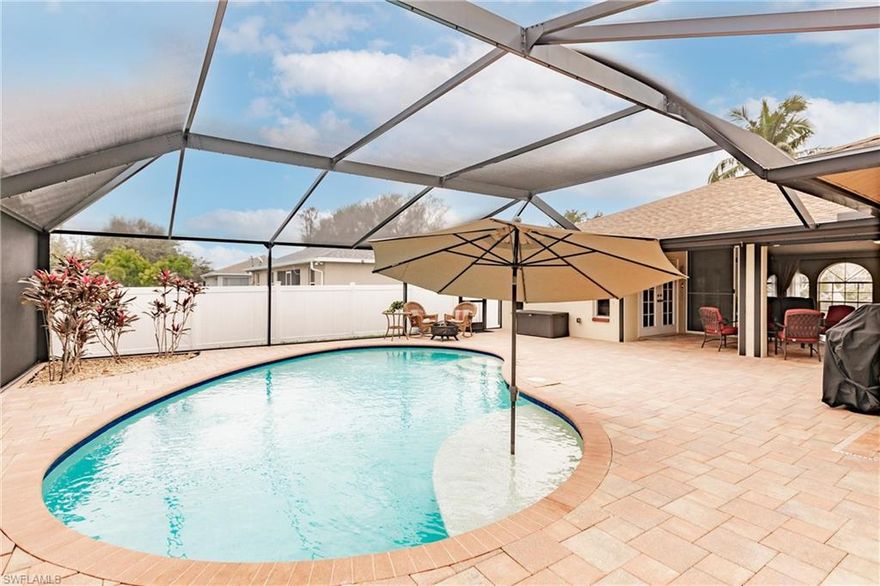 NO FLOOD INSURANCE NEEDED **** This 1703 sq ft home PLUS 1371 sq ft pool deck is perfect for entertaining. The salt water pool (2017) has a sun shelf and a heater/chiller. The 8 foot triple pocket sliding doors to pool deck allow expansion of living space – easily holding large gatherings. This house is prepared for Mother Nature. New Storm Smart motorized privacy and hurricane-rated fabric shutters can close off lanai, and hold 90% of A/C in at the touch of a button. New Front double door and all windows have roll-down hurricane shades to prepare quickly. Pool cage contains concrete-filled posts making it ultra-strong and is screened with “Super Screen” to keep even no-see-ums out. Home made it through an almost Cat 5 with no structural or roof damage. French doors open from the large main bedroom to the lanai, giving a breezy Key-West feel. Main suite includes two walk-in closets. New roof in 2021 with upgraded GAF shingles and 25 year warranty. Fenced back yard with fruit trees - key lime, large mango and coconut. 8 foot vinyl privacy fence with gates on both sides of the home. New Trane HVAC in 2018. Chest freezer in the garage to convey, as well as washer and dryer and shelves in garage. Be sure to check out attachment of upgrades and extras in the home. Home was just freshly painted a neutral light gray.